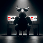 Powerful bull trader analyzing markets on XTB trading platform with dual screens